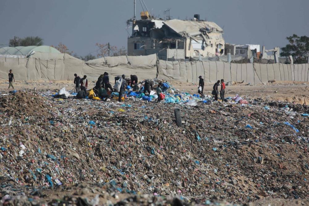 People search for salvageable items at a landfill in Khan Yunis, in the southern Gaza Strip, on Monday. AFP