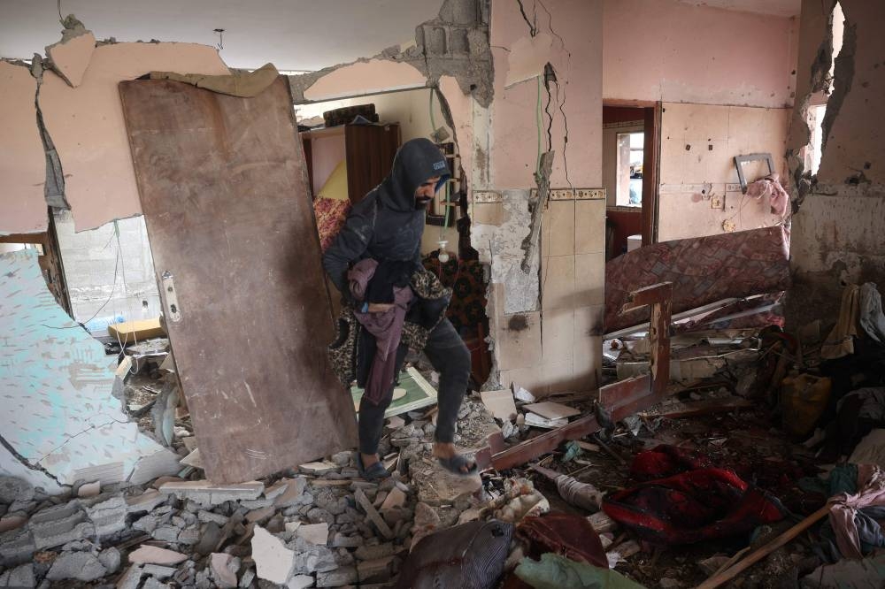 A Palestinian man checks the destruction in a house after an Israeli strike in the Nuseirat camp in the central Gaza Strip, on Tuesday. AFP