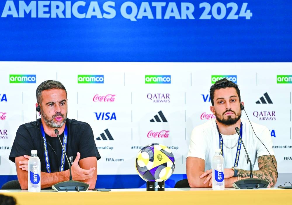 Botafogo coach Artur Jorge (left) speaks during a press conference as defender Alex Telles looks on at 974 Stadium on Tuesday.