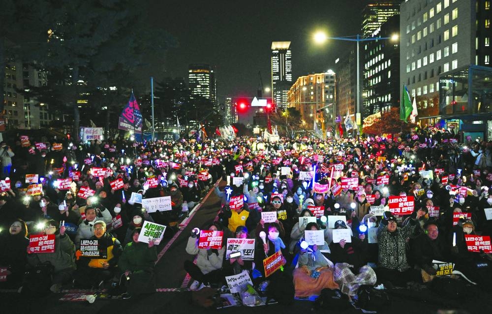 Protesters take part in a demonstration demanding Yoon’s resignation outside the National Assembly in Seoul on Tuesday. (AFP)