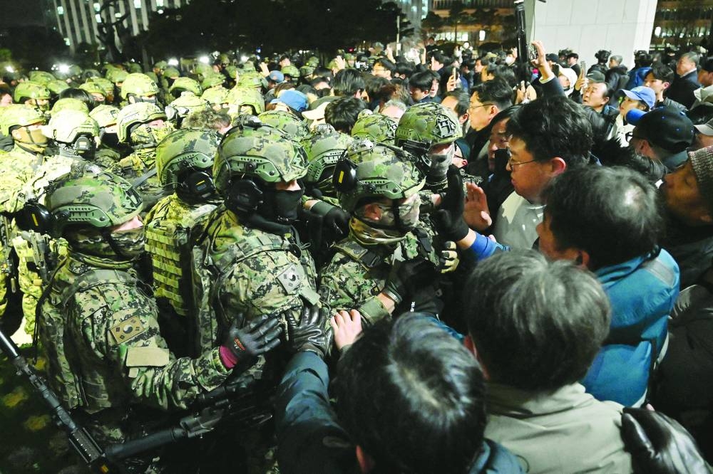 Soldiers try to enter the National Assembly building in Seoul on December 4 2024, after South Korea President Yoon Suk-yeol declared martial law. (AFP)