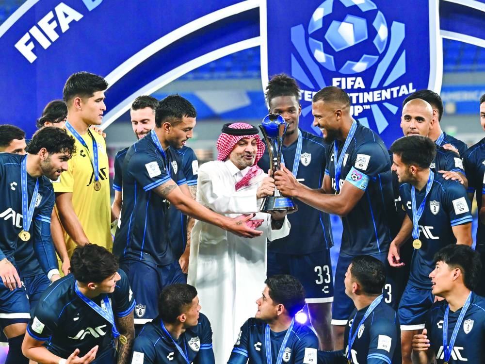 Chairman of the QFA’s Referees Committee Hani Taleb Ballan hands over the FIFA Derby of the Americas trophy to Pachuca’s players after the Mexican side beat Brazil’s Botafogo at Stadium 974 in Doha on Wednesday. PICTURE: Noushad Thekkayil