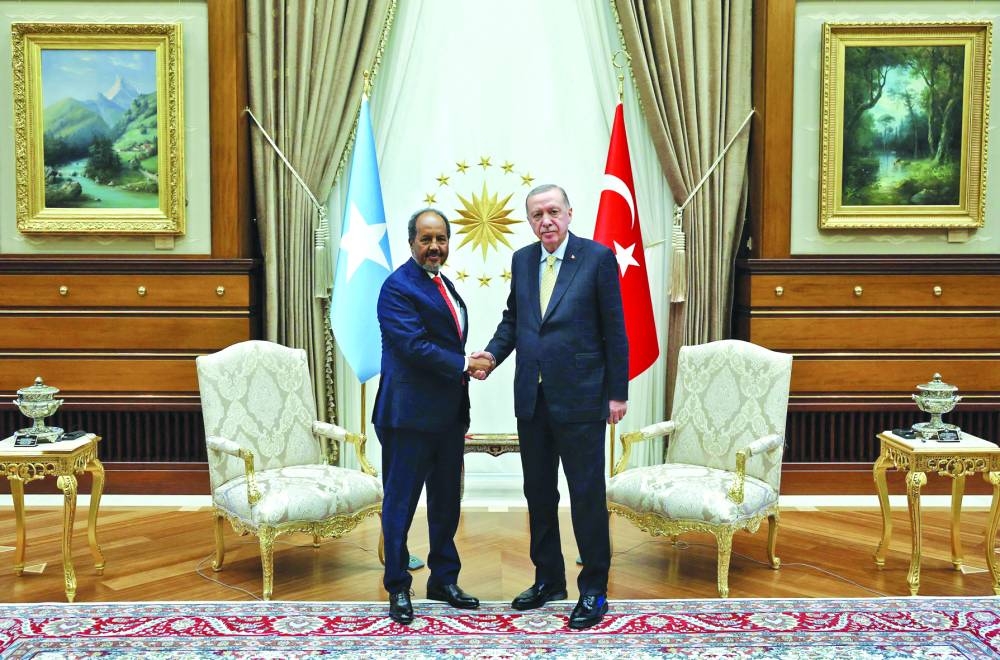 This handout photograph taken and released by the Turkish presidential press service on December 11, 2024, shows Turkish President Recep Tayyip Erdogan (R) greeting Somali President Hassan Sheikh Mohamud at the Presidential Palace in Ankara. State media outlet Sonna said President Hassan Sheikh Mohamud "has departed for Ankara at the official invitation of President Recep Tayyip Erdogan" on December 10, 2024, ahead of talks aimed at solving a nearly year-old bitter dispute between Mogadishu and Addis Ababa. (Photo by Handout / TURKISH PRESIDENTIAL PRESS SERVICE / AFP) / RESTRICTED TO EDITORIAL USE — MANDATORY CREDIT "AFP PHOTO / Turkish presidential press service" — NO MARKETING NO ADVERTISING CAMPAIGNS — DISTRIBUTED AS A SERVICE TO CLIENTS