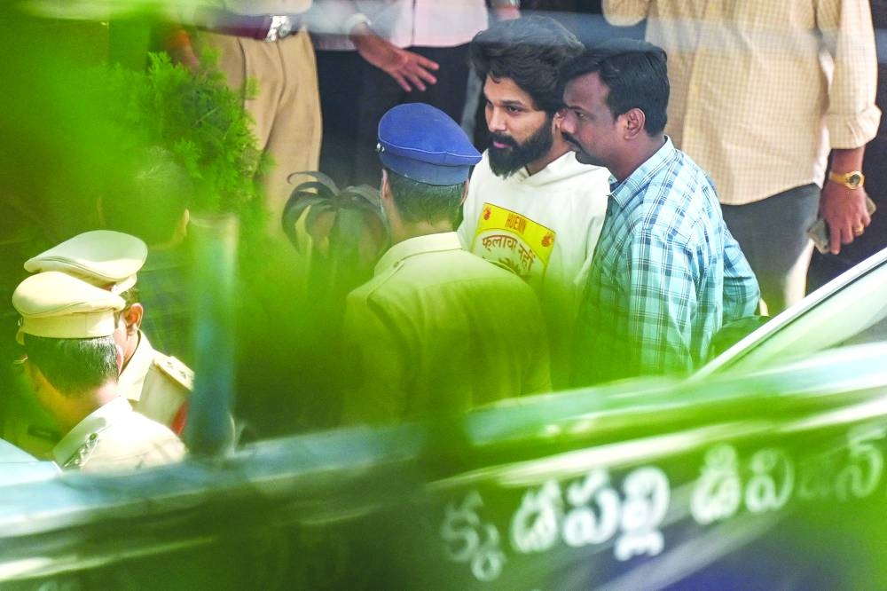Actor Allu Arjun (centre) comes out of the Chikkadpally police station following his arrest by the police in Hyderabad on Friday.
