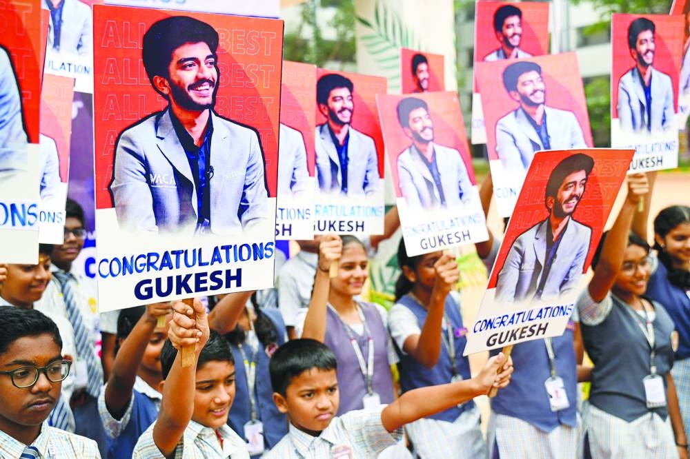 Indian school students congratulate the world’s youngest chess champion Gukesh Dommaraju, in Chennai on Friday.