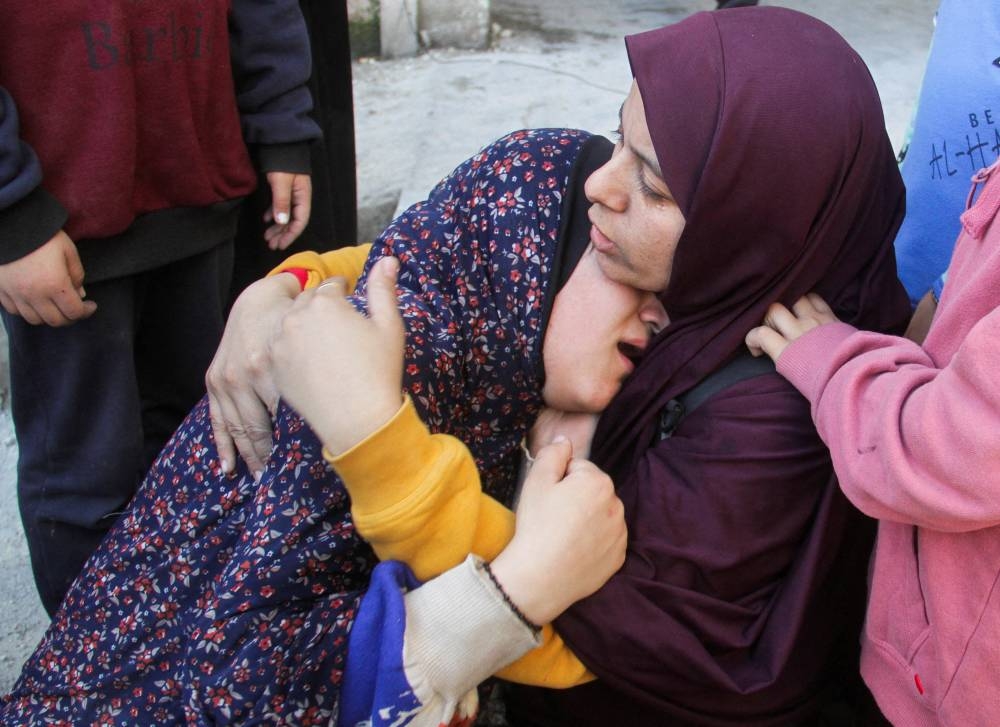 Palestinians react at the site of an Israeli strike on a school sheltering displaced people, in Gaza City, on Saturday. REUTERS