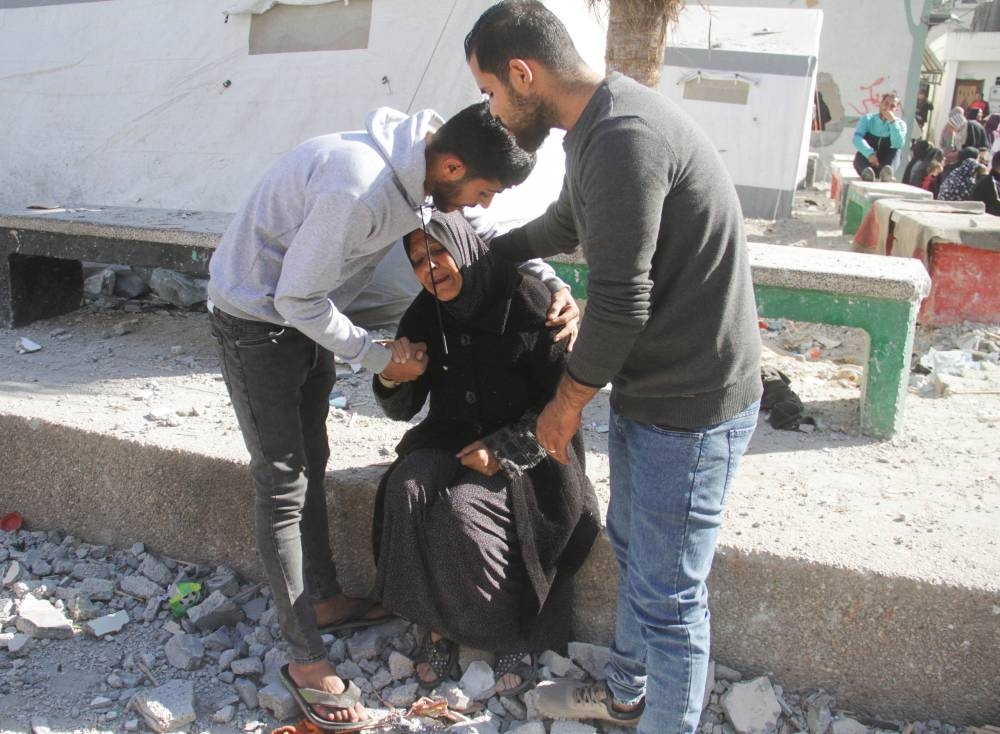 Palestinians react at the site of an Israeli strike on a school sheltering displaced people, in Gaza City, on Saturday. REUTERS