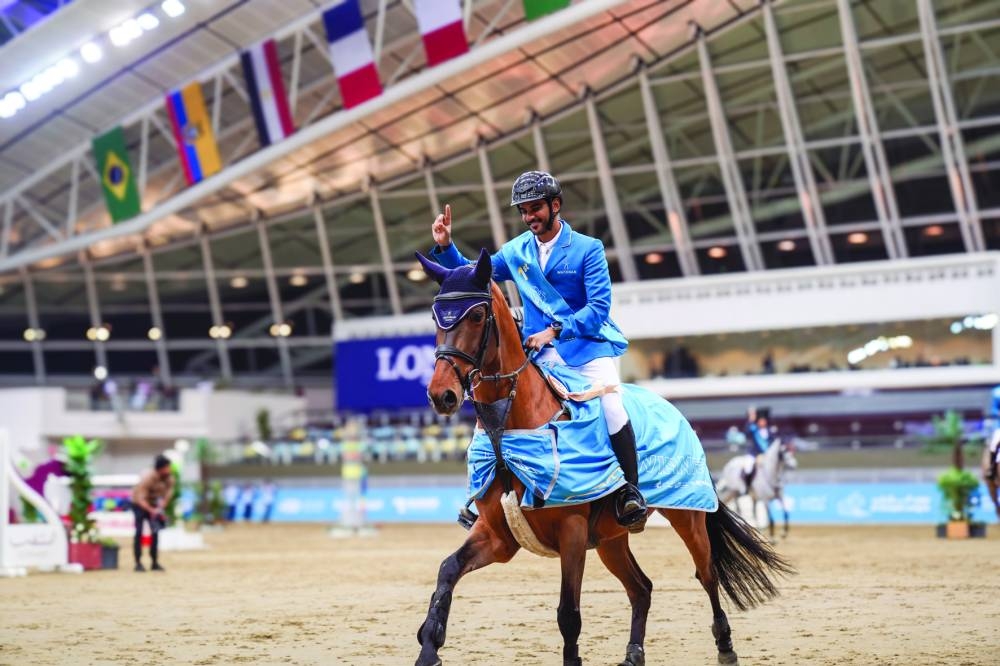 Mohammed Saeed Haidan celebrates with his nine-year-old stallion Popeye de Tamise after winning the Al Shaqab Champions 130cm class on Saturday.