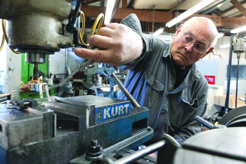 
Larry Bester creates machined parts for Boeing planes in his home-based Hobart Machined Products facility in Hobart, Washington. (Reuters) 