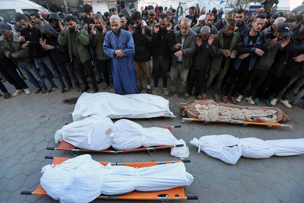 Mourners react during the funeral of Palestinians killed in an Israeli strike, at Al-Aqsa Martyrs Hospital, in Deir Al-Balah, in the central Gaza Strip, on Sunday. REUTERS