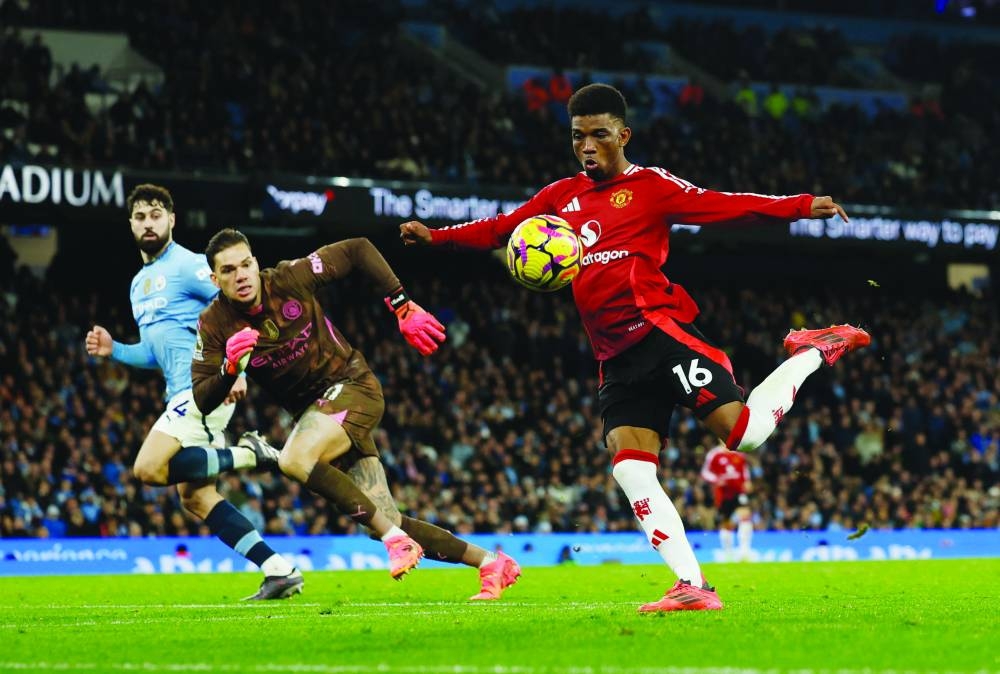 
Manchester United’s Amad Diallo scores against  Manchester City at the Etihad Stadium in Manchester yesterday. (Reuters) 
