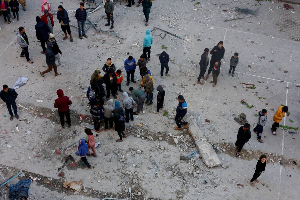 Palestinians inspect the damage in the aftermath of an Israeli strike on a school sheltering displaced people, in Khan Younis in the southern Gaza Strip, on Monday. REUTERS