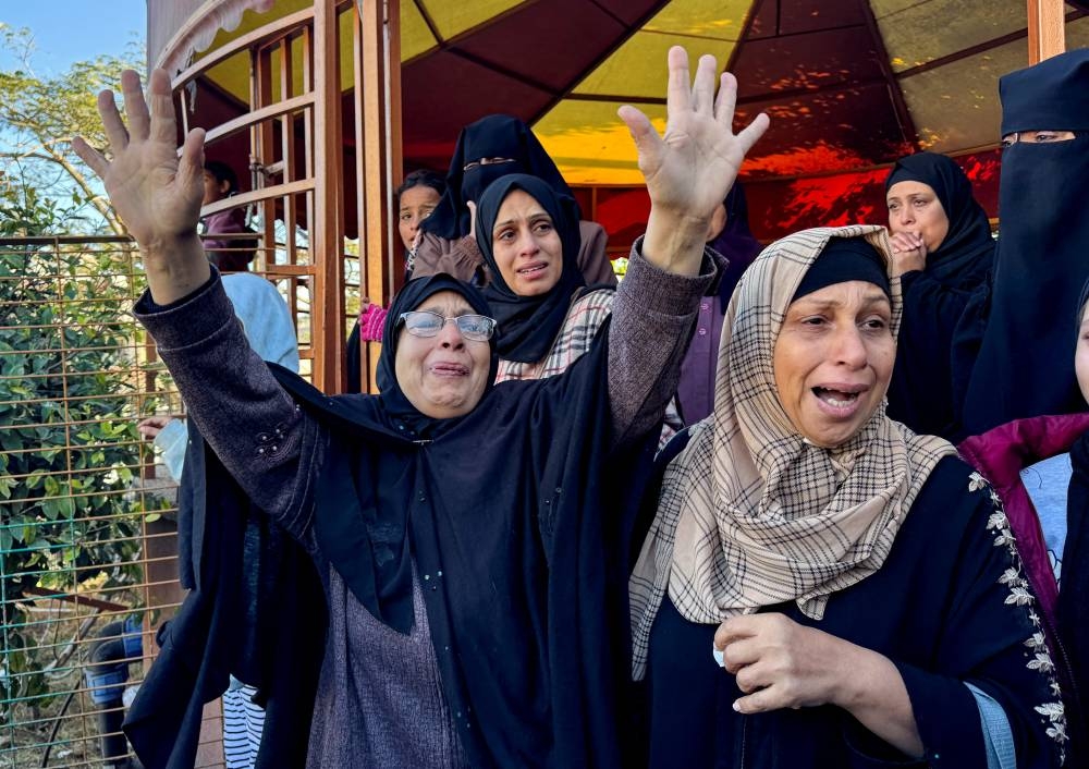 Mourners react during the funeral of Palestinians killed in Israeli strikes, at Nasser hospital, in Khan Younis in the southern Gaza Strip, on Monday. REUTERS