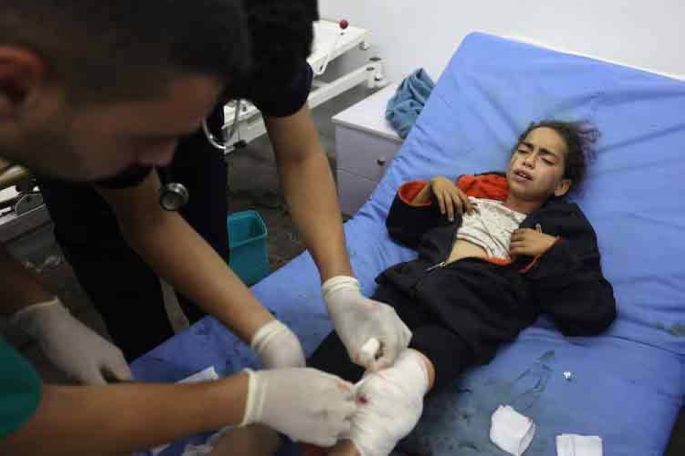 A Palestinian girl, wounded in an Israeli strike on a camp for displaced Gazans, receives treatment at a hospital in Rafah, May 26, 2024. AFP file picture