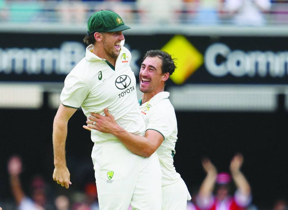 Australia’s Mitchell Marsh and Mitchell Starc celebrate an Indian wicket on Monday. (Reuters)