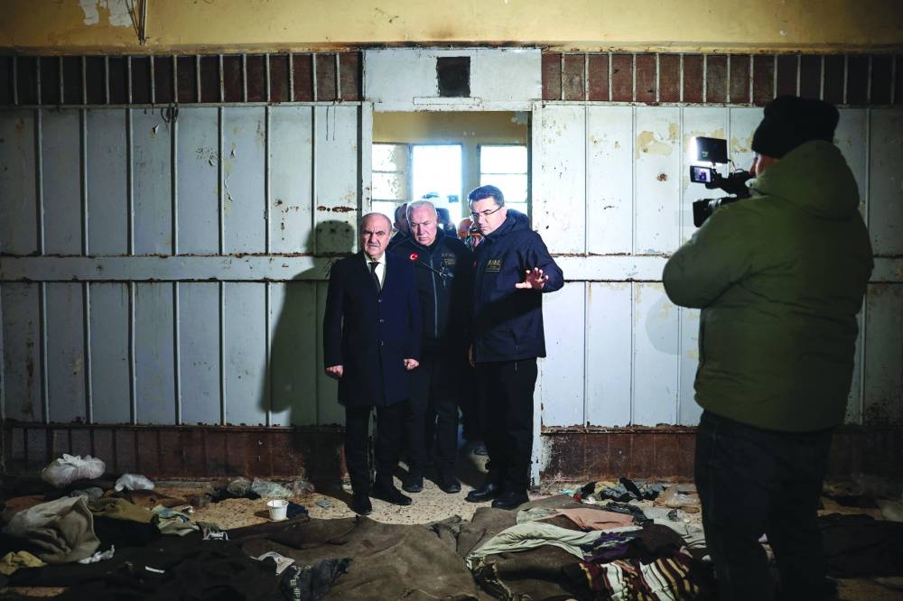 Members of Turkish AFAD disaster and emergency services searching for prisoners inspect the Saydnaya prison in Damascus, yesterday.