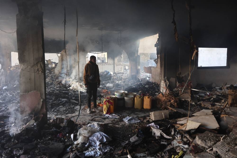 A Palestinian man inspects the damage at the site of an Israeli airstrike on a building in Gaza City's Daraj neighbourhood on Tuesday. AFP