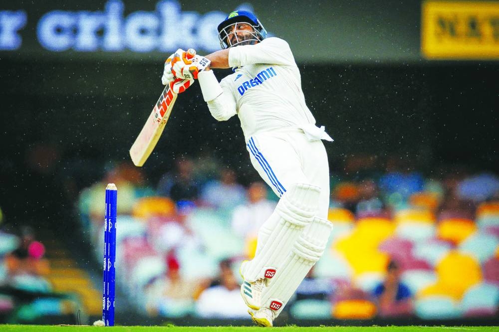 
India’s Ravindra Jadeja hooks Australia’s captain Pat Cummins on day four of the third Test at The Gabba in Brisbane yesterday. (AFP) 