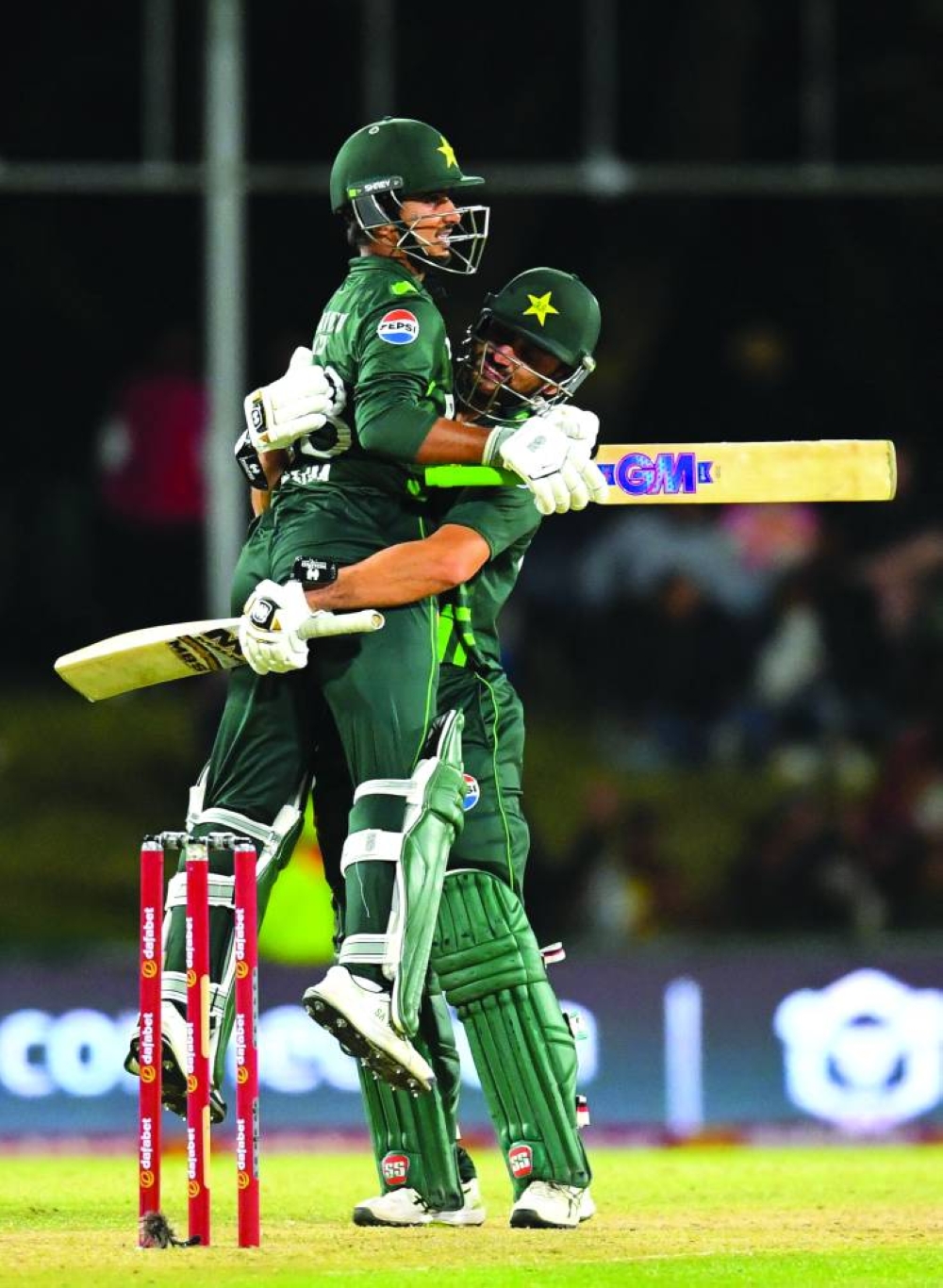Pakistan’s Saim Ayub (left) celebrates after scoring a century with teammate Salman Agha during the first one day international against South Africa at The Boland Oval in Paarl yesterday. (AFP)