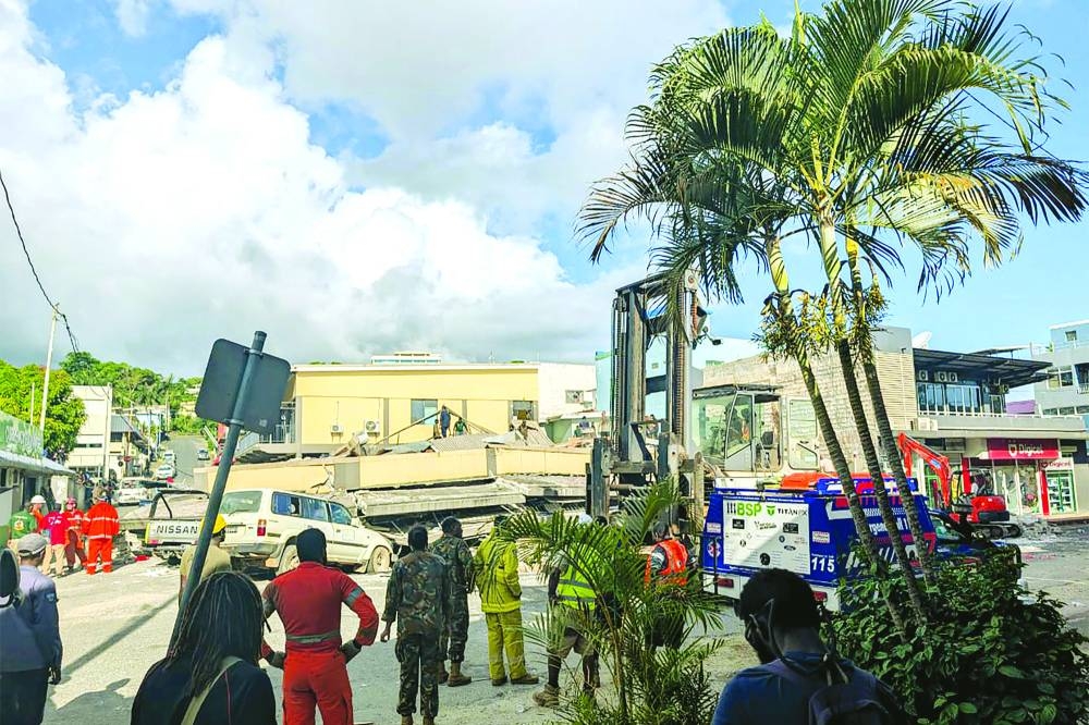 
Rescue workers arrive at the site of a collapsed building after a powerful earthquake struck Port Vila, the capital city of Vanuatu, yesterday. 