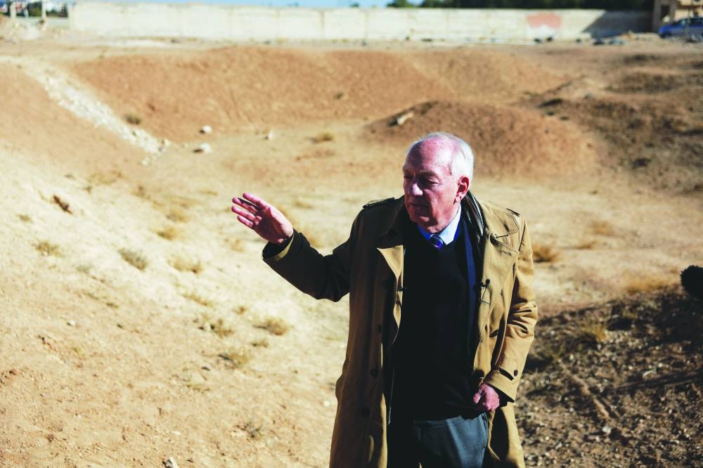 
Stephen Rapp, head of Commission for International Justice and Accountability, talks with media as people inspect the site of a mass grave from the rule of Syria’s Bashar al-Assad, according to residents, after the ousting of the leader, in Najha, yesterday. 