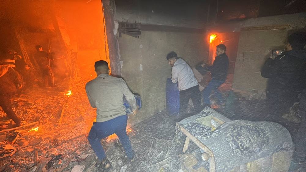 Palestinians try to extinguish a fire inside a house near Kamal Adwan hospital, in Beit Lahiya, in the northern Gaza Strip, on Tuesday. REUTERS