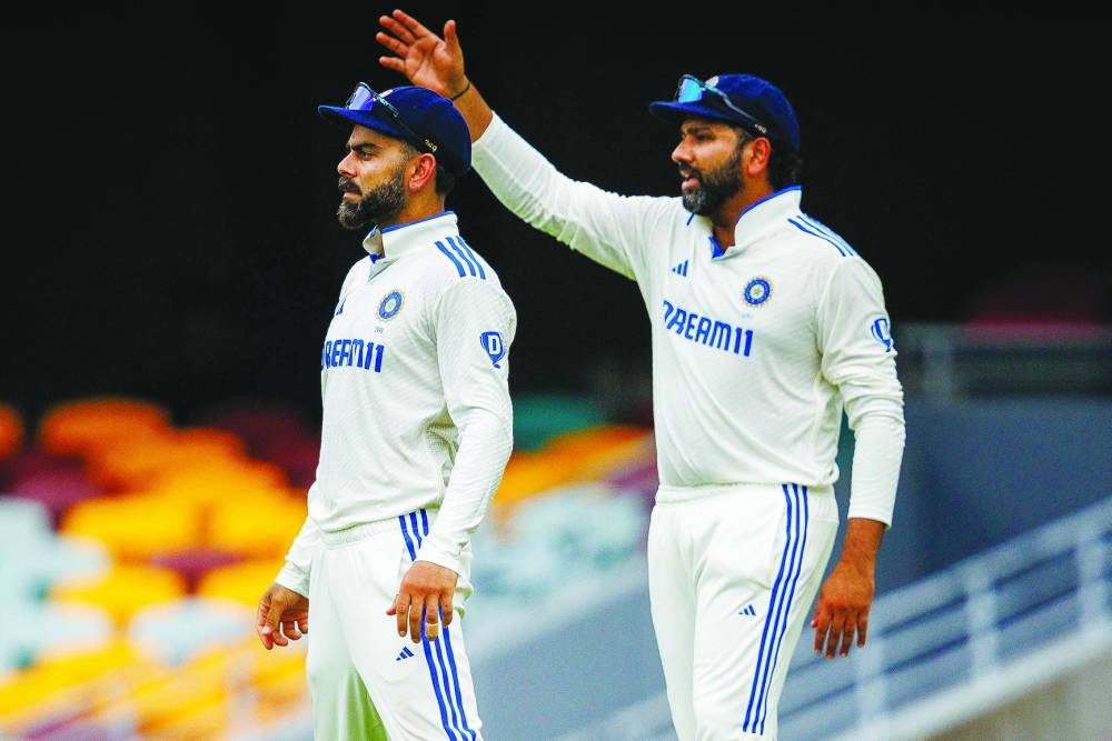 India’s captain Rohit Sharma (right) gestures next to Virat Kohli during day five of the third Test against Australia at The Gabba in Brisbane on Wednesday. (AFP)