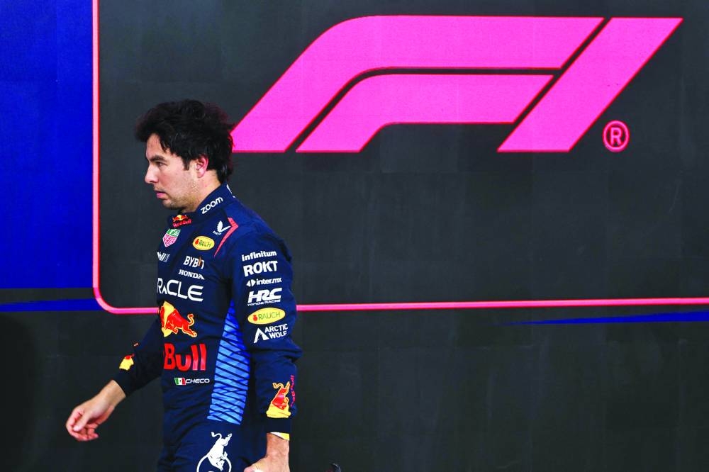 
Red Bull Racing’s Mexican driver Sergio Perez walks to his garage after the qualifying session ahead of the Abu Dhabi Formula One Grand Prix at the Yas Marina Circuit in Abu Dhabi on December 7, 2024. (AFP) 