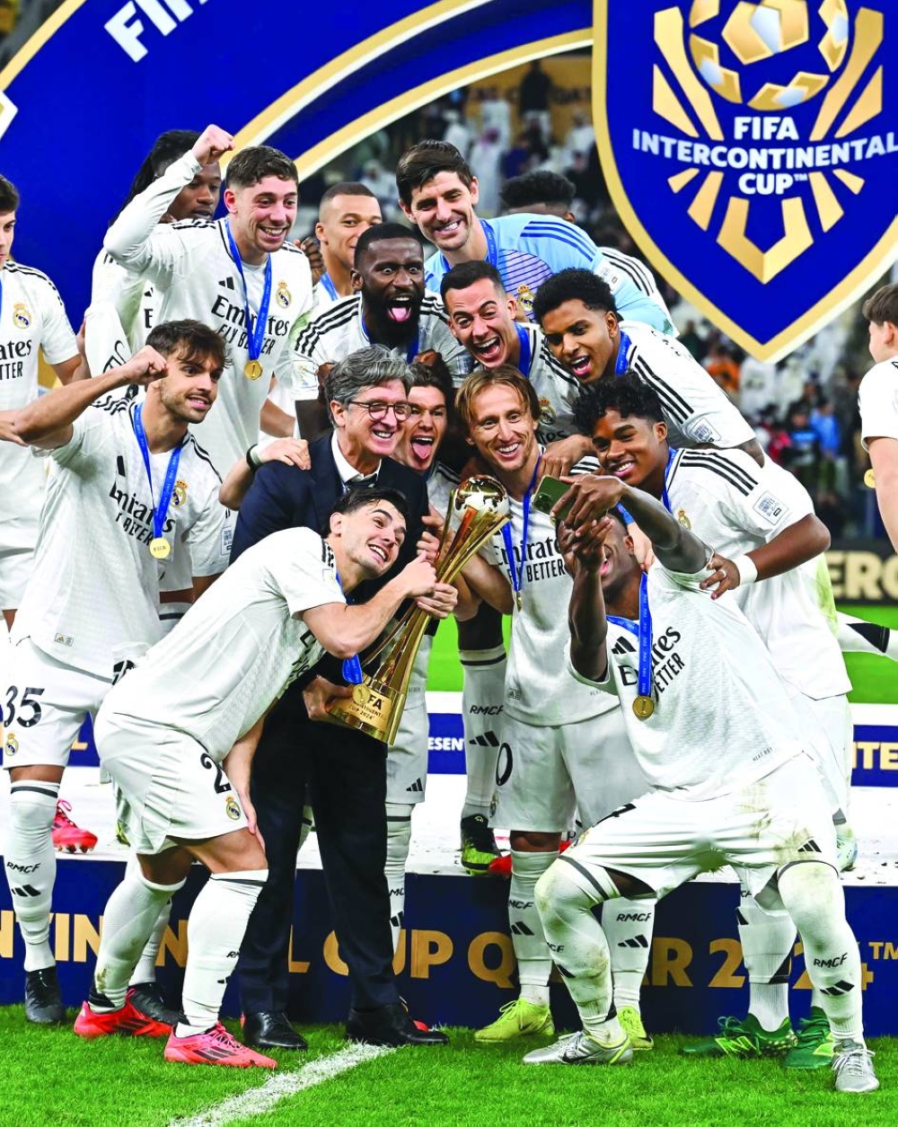 Real Madrid’s Vinicius Junior takes a selfie with teammates and the trophy after winning the Intercontinental Cup at the Lusail Stadium on Wednesday. PICTURE: Noushad Thekkayil