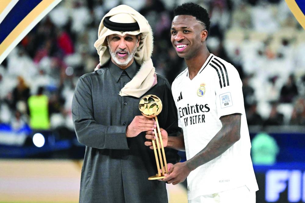 Sports and Youth Minister HE Sheikh Hamad bin Khalifa bin Ahmed al-Thani presents Real Madrid's Brazilian forward Vinicius Junior with the golden ball trophy after the 2024 FIFA Intercontinental Cup final against Mexico's Pachuca at the Lusail Stadium in Doha Wednesday.