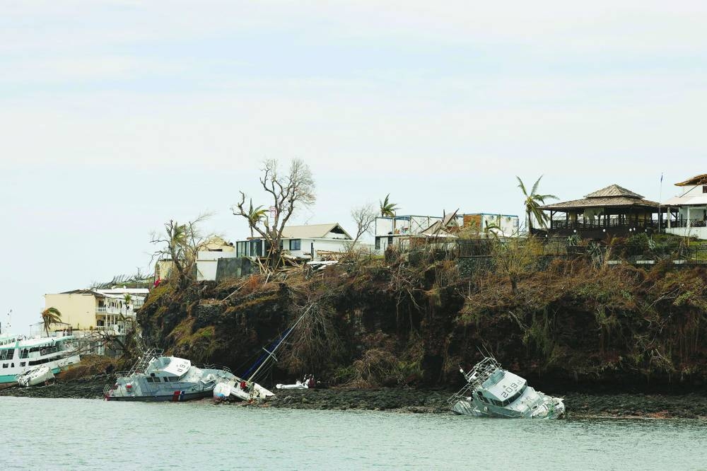 This photograph shows damage in the city of Mamoudzou, on the French Indian Ocean territory of Mayotte, on December 19, 2024, after the cyclone Chido hit the archipelago. Rescuers raced against time to reach survivors and supply urgent aid after the devastating cyclone Chido ripped through the French Indian Ocean territory of Mayotte, destroying homes across the islands, with hundreds feared dead. (Photo by Ludovic MARIN / AFP)