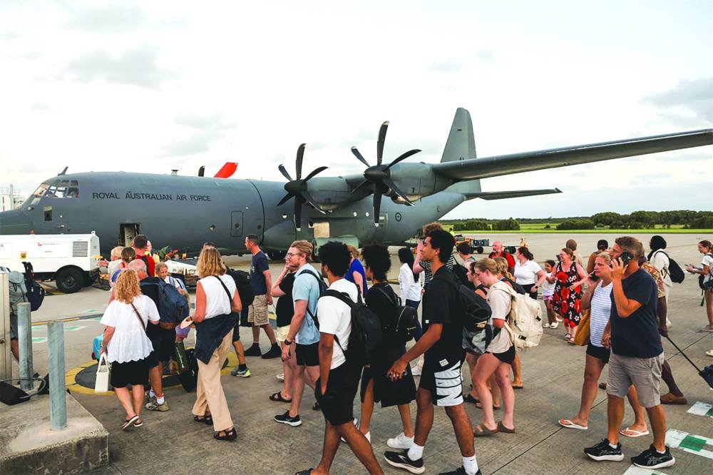 
Australian Defence Force personnel assisting Australians off a C-130J Hercules at Brisbane Airport following an earthquake which struck Port Vila, Vanuatu. Rescuers say they have expanded a search for trapped survivors in quake-rocked Vanuatu to “numerous places of collapse” beyond the capital, after the death toll climbed to at least 10. 