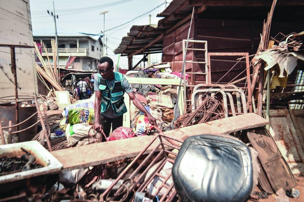 
Self-thought innovator James Samba collects scrap metals in Freetown. 