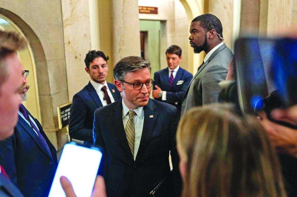 
Left: US Speaker of the House Mike Johnson speaks with reporters at the US Capitol, in Washington, DC. (AFP) 
