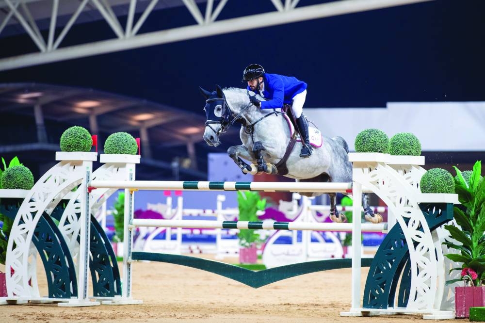 Qatari rider Khalid Mohammed al-Emadi astride Chikitaa in action during the Big Tour of Qatar Equestrian Tour - Longines Hathab on Saturday. Bassem Hassan Mohammed (centre) receives the Big Tour of Qatar Equestrian Tour - Longines Hathab winner’s trophy from Ali Yousef al-Rumaihi, Assistant Secretary-General of QEF, at Al Shaqab on Saturday.