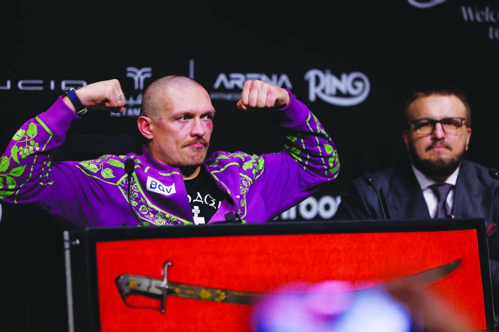 Oleksandr Usyk during a press conference with promoter Alex Krassyuk after winning his fight against Tyson Fury in Riyadh. (Reuters)