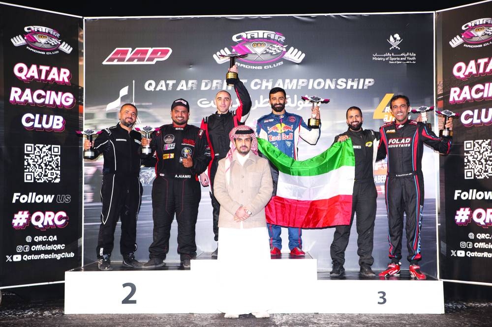 Qatar Racing Club Director Sheikh Jabor bin Khalid al-Thani poses with the winners of the fourth round of the Qatar Drift Championship.