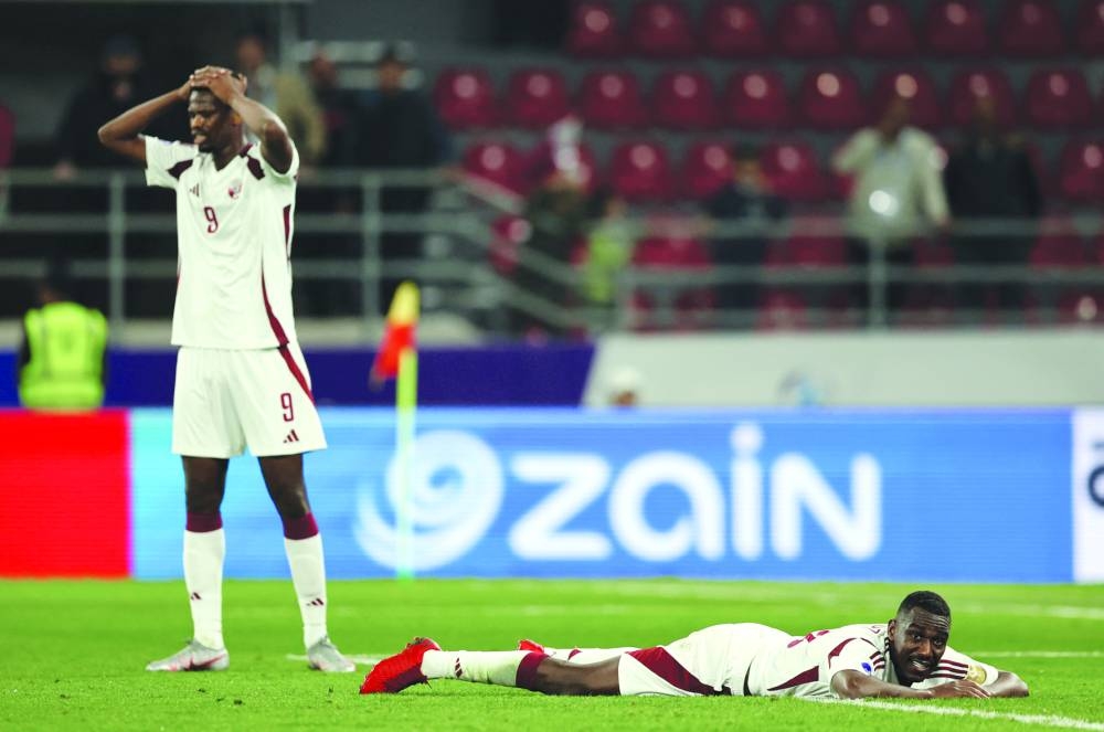 Qatar’s Mohammed Muntari (left) and Almoez Ali looks dejected after the loss to Oman at the Jaber Al Mubarak Al Hamad Stadium in Sulaibikhat, Kuwait, on Tuesday.