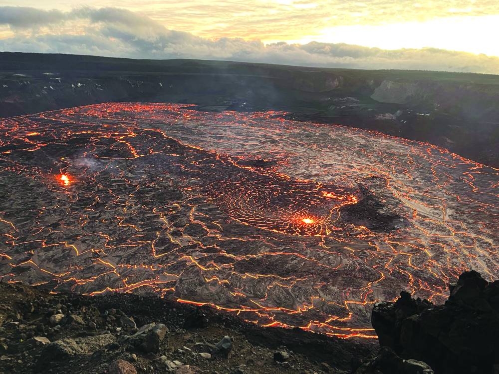 
A lake of active lava in the summit caldera glows as the sun rises during a new eruption at Kilauea volcano in Hawaii. (Reuters) 