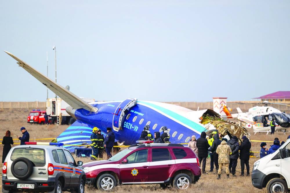 Emergency specialists work at the crash site of an Azerbaijan Airlines passenger jet near Aktau on Wednesday 