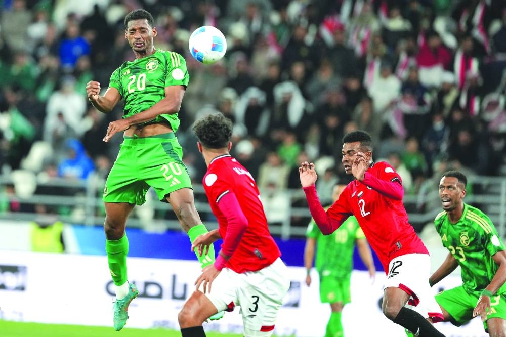 
Saudi Arabia and Yemen players vie for the ball.  