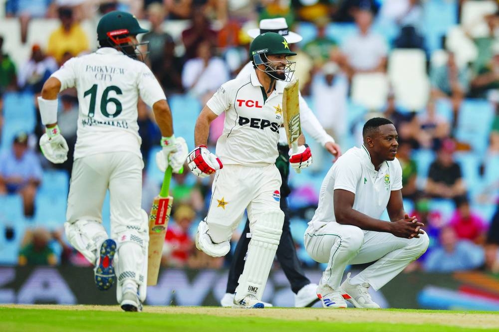 
South Africa’s Kagiso Rabada (right) reacts as Pakistan’s Kamran Ghulam (centre) and Mohammad Rizwan run between the wickets during day one of the first Test. (AFP) 