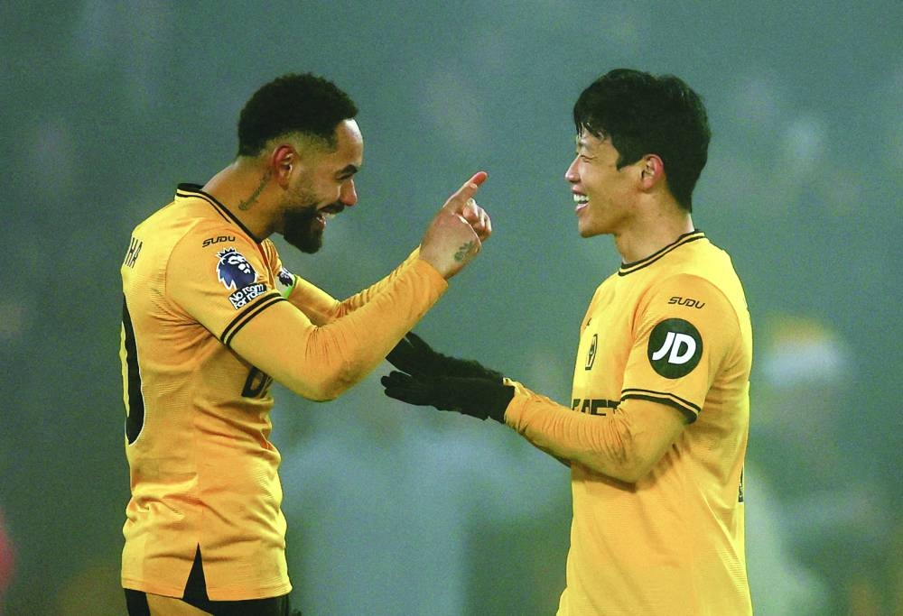 Wolverhampton Wanderers’ Hwang Hee-chan (right) celebrates with Matheus Cunha after scoring their second goal against Manchester United in Wolverhampton on Thursday. (Reuters)