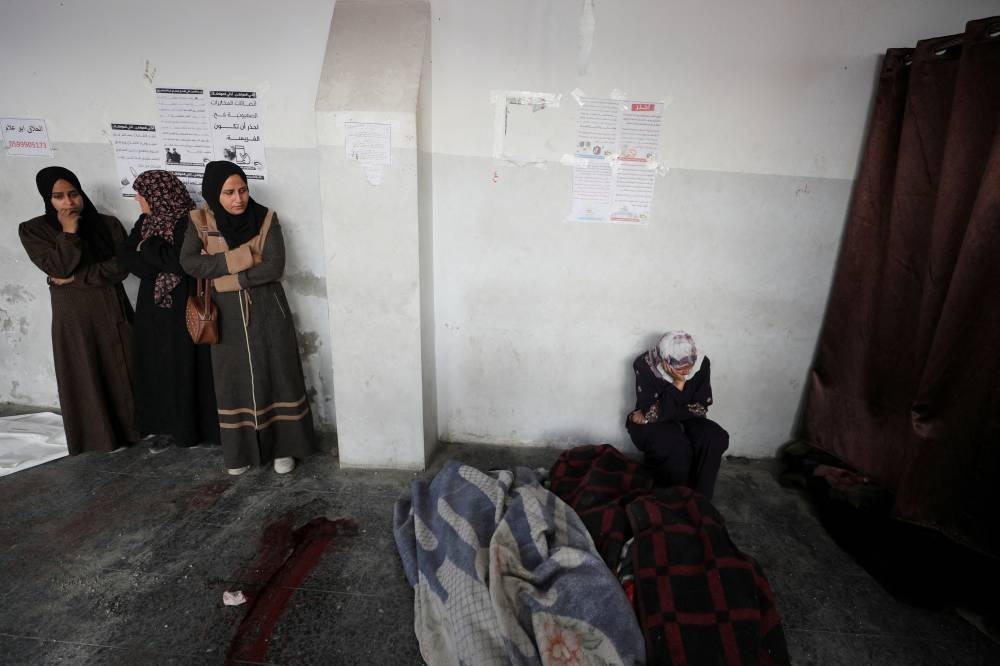 Mourners react next to the bodies during the funeral of Palestinians killed in Israeli airstrikes, in Gaza City, on Friday. REUTERS