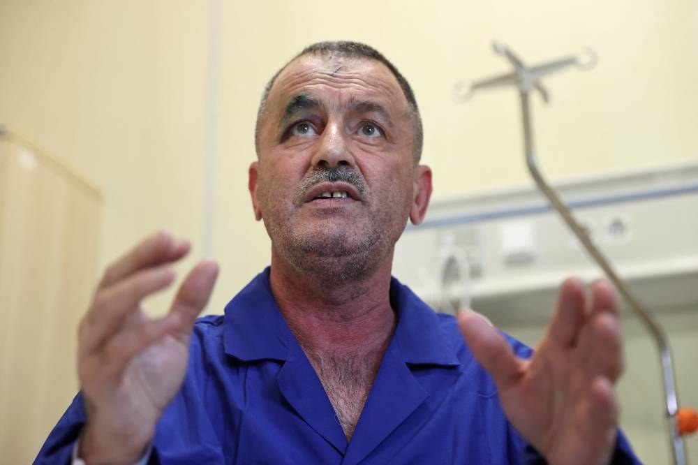 Zulfugar Asadov, a flight attendant on the Azerbaijan Airlines plane that crashed in Kazakhstan, speaks during an interview with Reuters as he receives treatment at a hospital in Baku, Azerbaijan, on Friday. REUTERS
