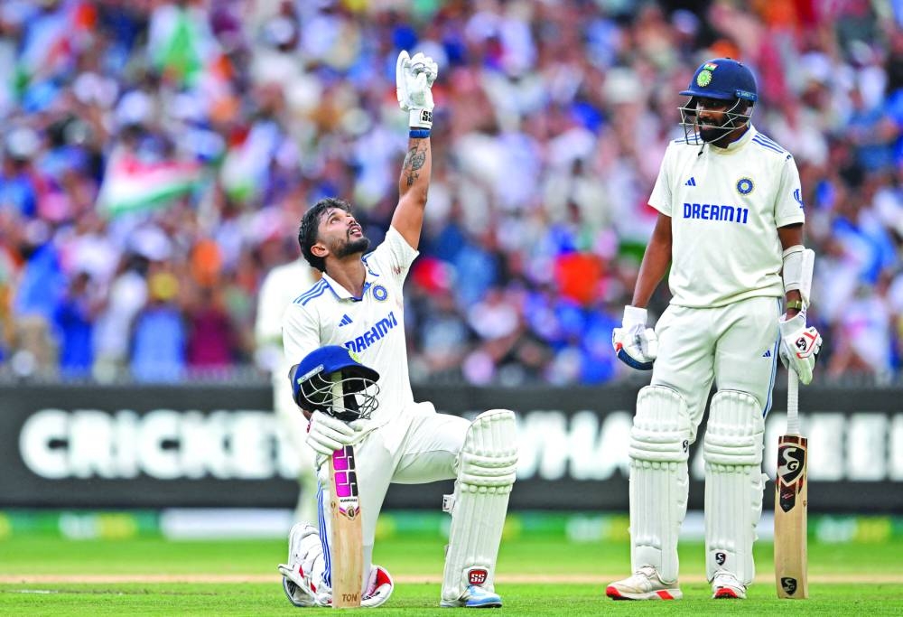 India’s Nitish Kumar Reddy celebrates his century as Mohammed Siraj looks on during the fourth Test against Australia at the Melbourne Cricket Ground on Saturday.  (AFP)