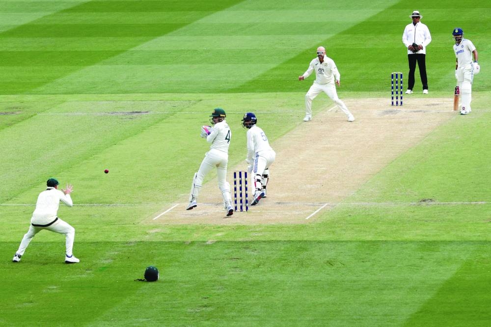 Australia’s Steve Smith (left) takes a catch to dismiss India’s Washington Sundar from the bowling of Nathan Lyon during the fourth Test against Australia at the Melbourne Cricket Ground on Saturday. (AFP)