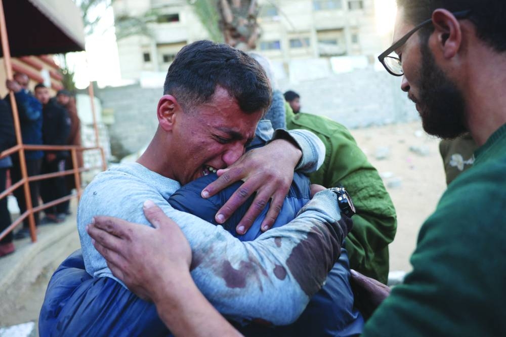 
A Palestinian man mourns a relative, killed in an Israeli strike, at the Nasser Hospital in Khan Yunis in the southern Gaza Strip yesterday. (AFP) 