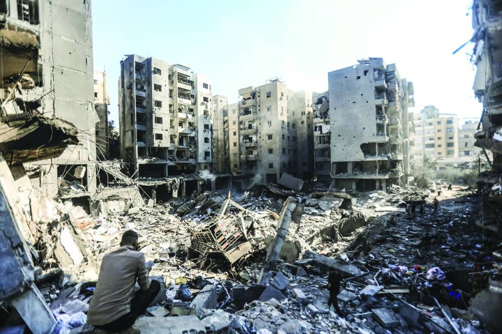 People look through the rubble of buildings which were levelled on September 27 by Israeli strikes that targeted and killed Hezbollah leader Hassan Nasrallah, in the Haret Hreik neighbourhood of Beirut’s southern suburbs. (AFP)