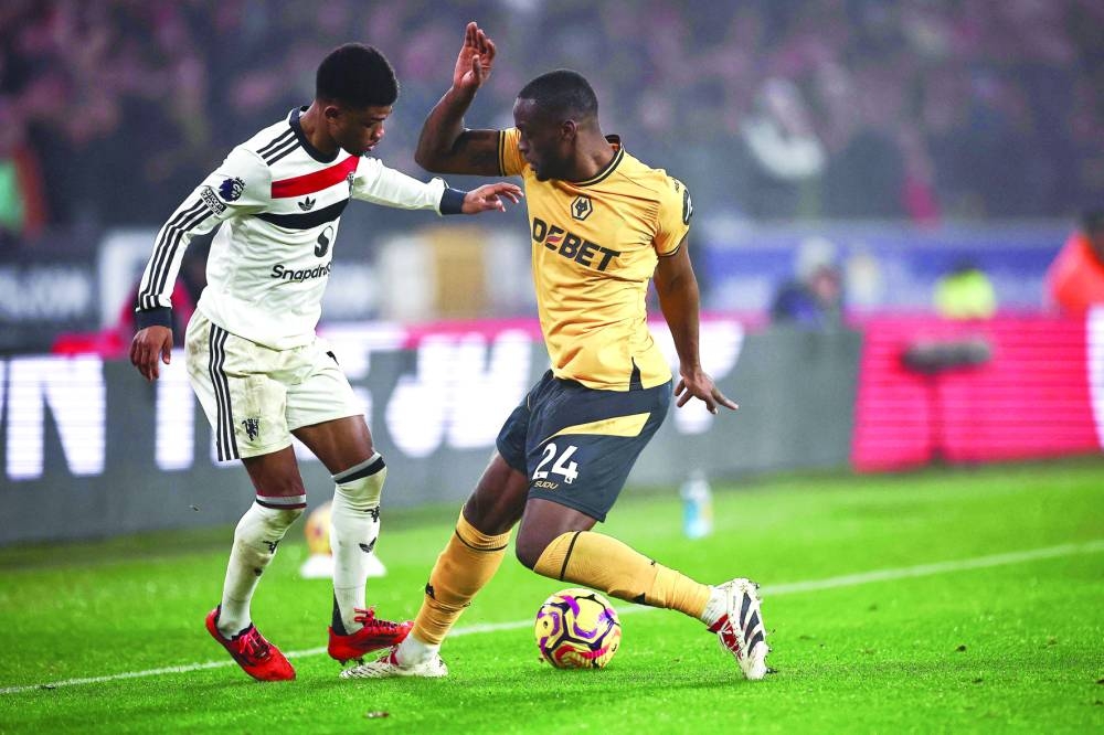 
Manchester United’s midfielder Amad Diallo (left) battles for the ball with Wolverhampton Wanderers’ defender Tote Gomes during the English Premier League match in Wolverhampton on Thursday. (AFP) 